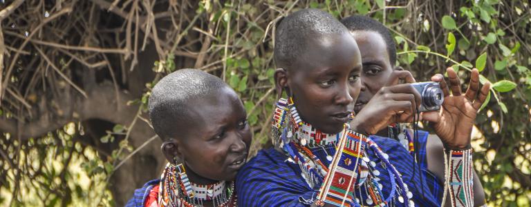 Kenyan women looking through a camera lens